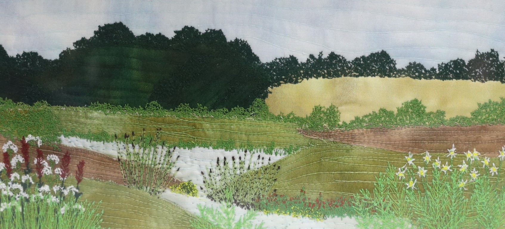 Textile landscape design by L Reynolds. Signed outside the plate. 14 x 29cm